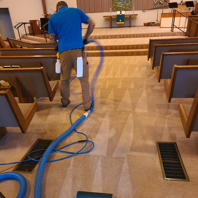 A man Cleaning the couch